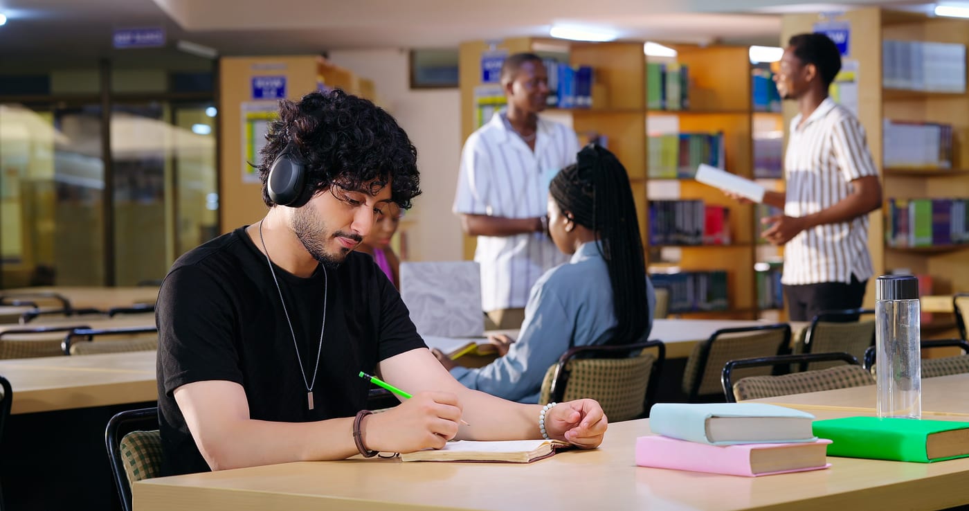 Focused student with headphones - Oneura vs BetterSleep for ADHD focus and neurodivergent sleep sounds
